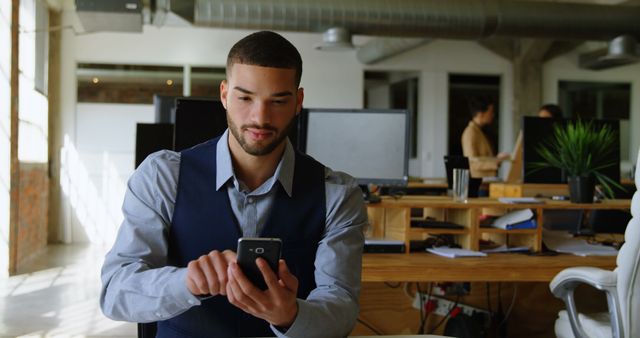 Young Professional Working on Smartphone in Modern Office - Download Free Stock Images Pikwizard.com