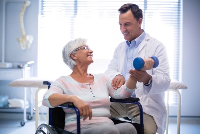 Physiotherapist assisting senior patient with hand exercise - Download Free Stock Photos Pikwizard.com