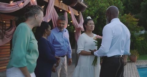 Senior Multicultural Couple Exchanging Garden Wedding Vows