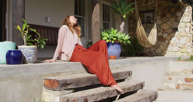 Woman Relaxing on Porch Steps on Sunny Day - Download Free Stock Images Pikwizard.com