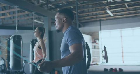 Athletic Man Skipping Rope in Modern Boxing Gym