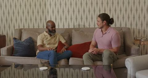 Two Men Engaged in Thoughtful Conversation in Cozy Living Room