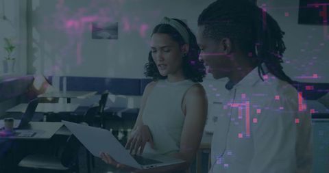 Collaborating Professionals Analyzing Data in Tech Office