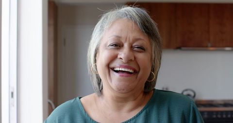 Senior African American Woman Smiling in Modern Kitchen