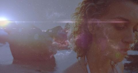 Woman in Swimsuit Gazing at Serene Shoreline During Idyllic Sunset