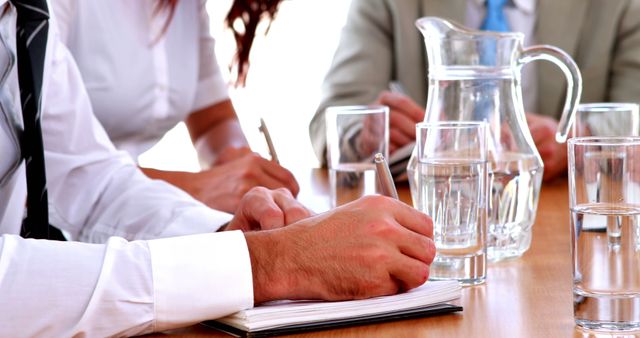 Business Meeting with Water Jugs and Notebooks on Table - Download Free Stock Images Pikwizard.com