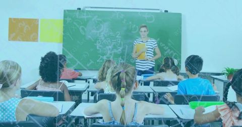 Teacher explains math concepts to attentive class of students