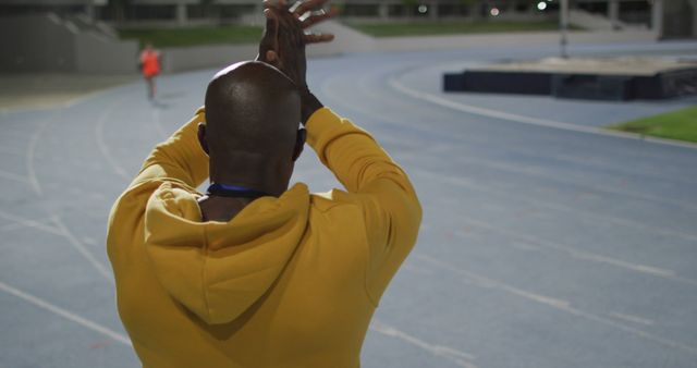 Coach Clapping on Sports Track Under Stadium Lights - Download Free Stock Images Pikwizard.com