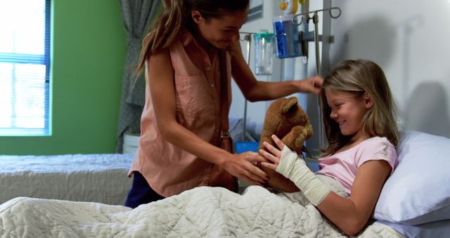 Mother comforting daughter with teddy bear in hospital bed - Download Free Stock Images Pikwizard.com