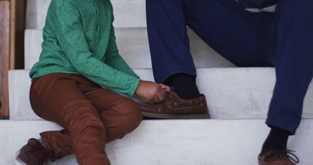 Child Tying Shoe Laces of Adult On Stairs Showing Bonding Moment - Download Free Stock Images Pikwizard.com