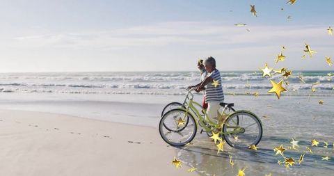 Couple Pushing Bikes on Tranquil Beach with Starry Accents