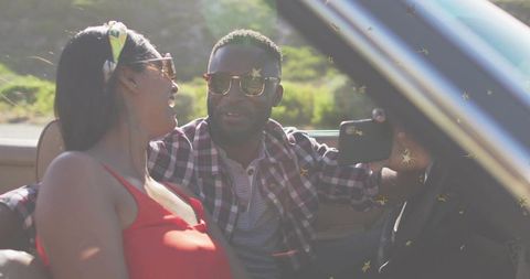 Laughing couple taking selfie in convertible on sunny road trip | summer travel romance