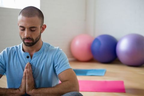 Man Practicing Meditation in Studio with Exercise Balls