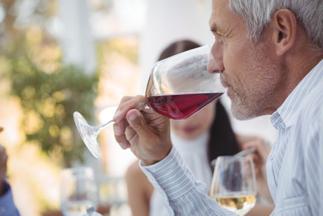 Close-up of man having wine at the restaurant