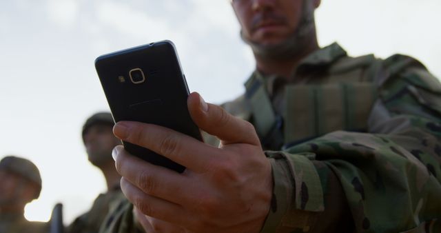 Soldier using Smartphone Outdoors During Military Operation - Download Free Stock Images Pikwizard.com