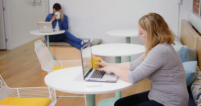 Casual Workspace with People Using Laptops and Drinking Coffee - Download Free Stock Images Pikwizard.com