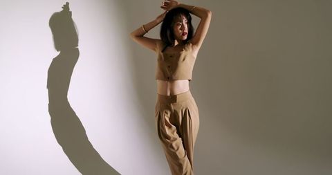 Elegant Asian Woman Posing in Minimalist Fashion Ensemble