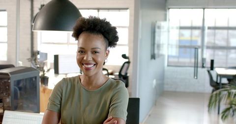 Confident Businesswoman Sitting and Smiling in Office - Download Free Stock Images Pikwizard.com