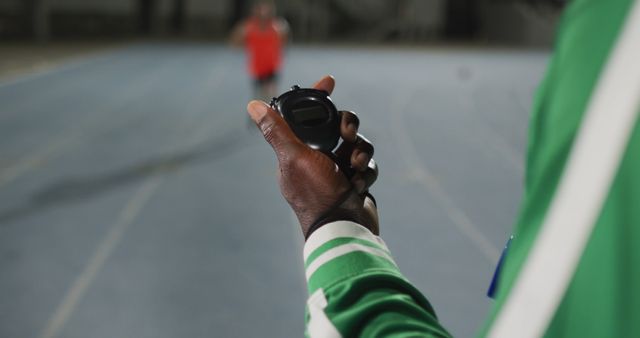 Coach Timing Runner on Track with Stopwatch - Download Free Stock Images Pikwizard.com