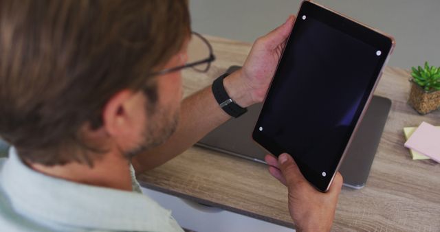 Man Using Digital Tablet at Desk for Remote Work or Study - Download Free Stock Images Pikwizard.com