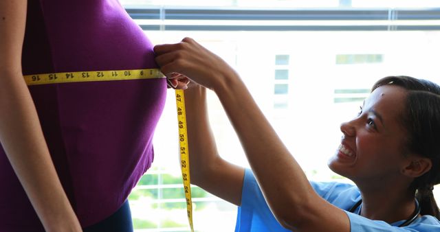 Pregnant Woman Getting Waistline Measured by Friendly Nurse - Download Free Stock Images Pikwizard.com