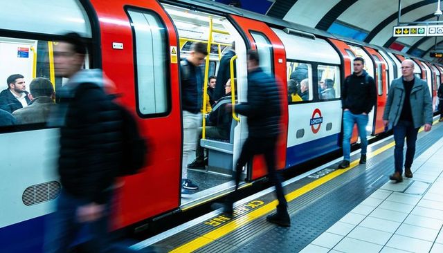 London underground tube train boarding rush hour motion blur commuter transit scene