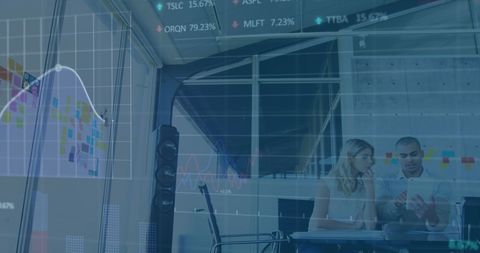 Business Professionals Analyzing Stock Market Trends in Modern Office