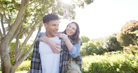 Joyful Couple Enjoying Sunny Day in Lush Green Garden