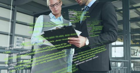 Business Professionals Reviewing Digital Data with Overlayed Code