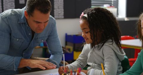 Engaged Teacher Helping Student Learning in Classroom - Download Free Stock Images Pikwizard.com