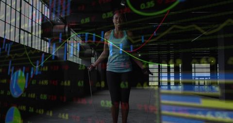 Woman jumping rope in urban warehouse with financial chart overlay