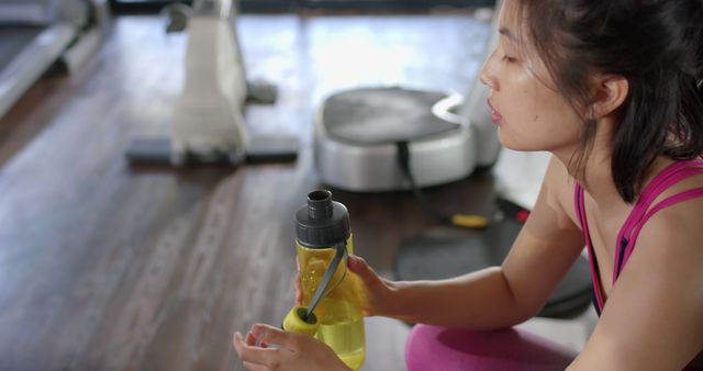 Woman Taking Hydration Break During Gym Workout - Download Free Stock Images Pikwizard.com