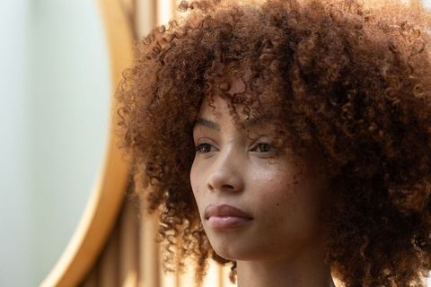 African american woman bathed in warm natural light, closeup curly hair portrait, soft glow