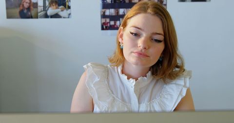 Focused female designer working on computer at office desk