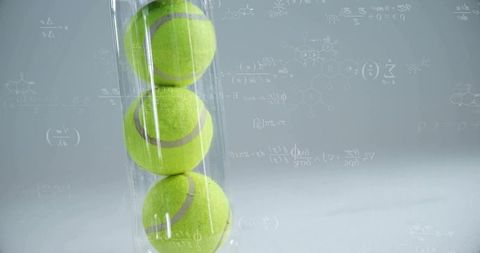 Green tennis balls in transparent tube with scientific formula overlay