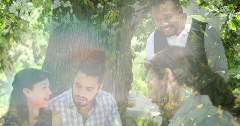 Friends Enjoying Picnic and Wine Outdoors