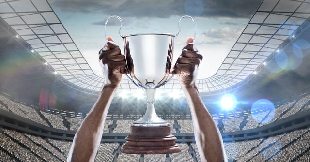 Hands holding a champions trophy against stadium in background - Download Free Stock Photos Pikwizard.com