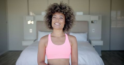 Smiling Woman in Sports Bra Ready for Indoor Workout