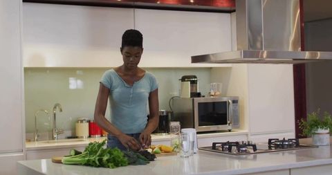 Woman Preparing Fresh Produce in Modern Kitchen Interior