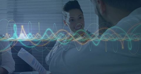 Colleagues Discussing Report with Data Waveform Overlay Conference Room