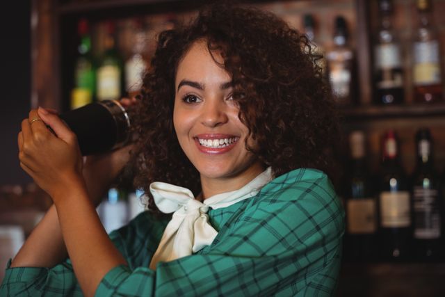 Smiling Female Bartender Shaking Cocktail in Bar - Download Free Stock Photos Pikwizard.com