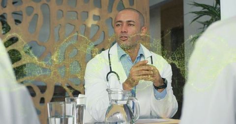 Confident Doctor Leading Collaborative Medical Discussion Meeting