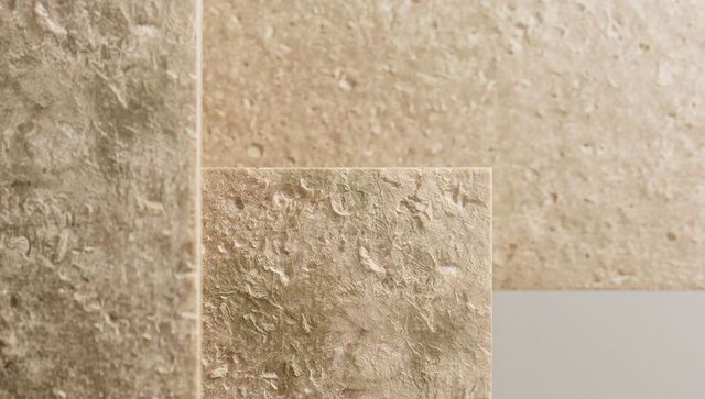 Textured beige plaster panels layering with pale gray accent strip for minimalist design