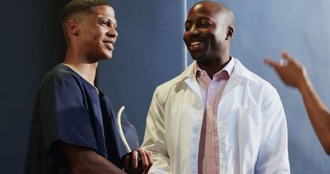 Successful professionals celebrating achievement with award