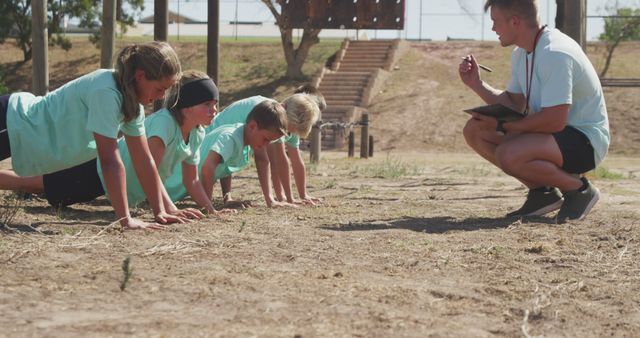 Kids in Sports Camp Practicing Push-ups with Coach - Download Free Stock Images Pikwizard.com