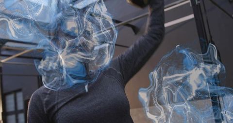 Mid adult woman pressing kettlebell overhead with blue overlay for strength training