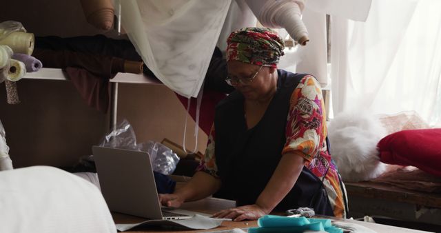 African Woman Seamstress Using Laptop in Fabric Workshop - Download Free Stock Images Pikwizard.com