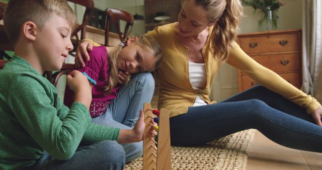 Mother and Two Children Playing Game Together at Home - Download Free Stock Images Pikwizard.com