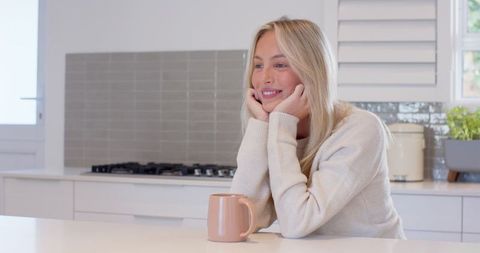 Blonde Woman Smiling Relaxed in Modern Minimalist Kitchen