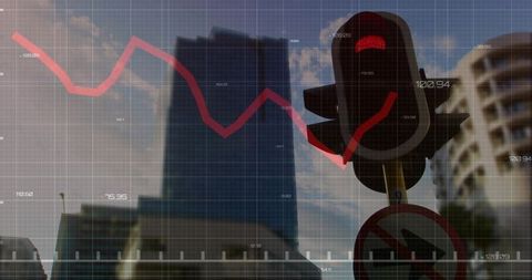 Red traffic signal halting urban market trend overlay over glass tower skyline